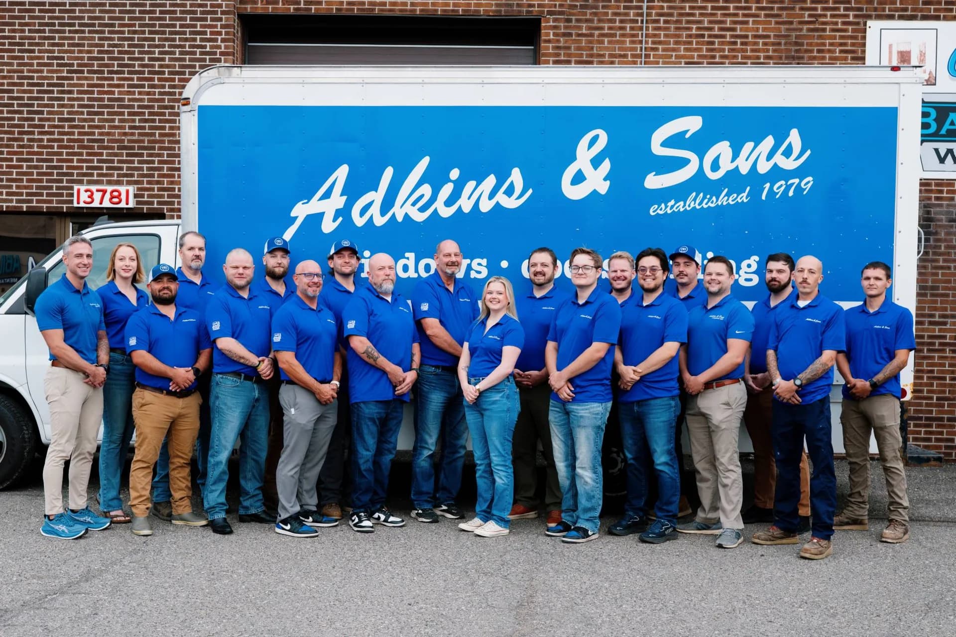 The Adkins & Sons team lined up in front of the company truck