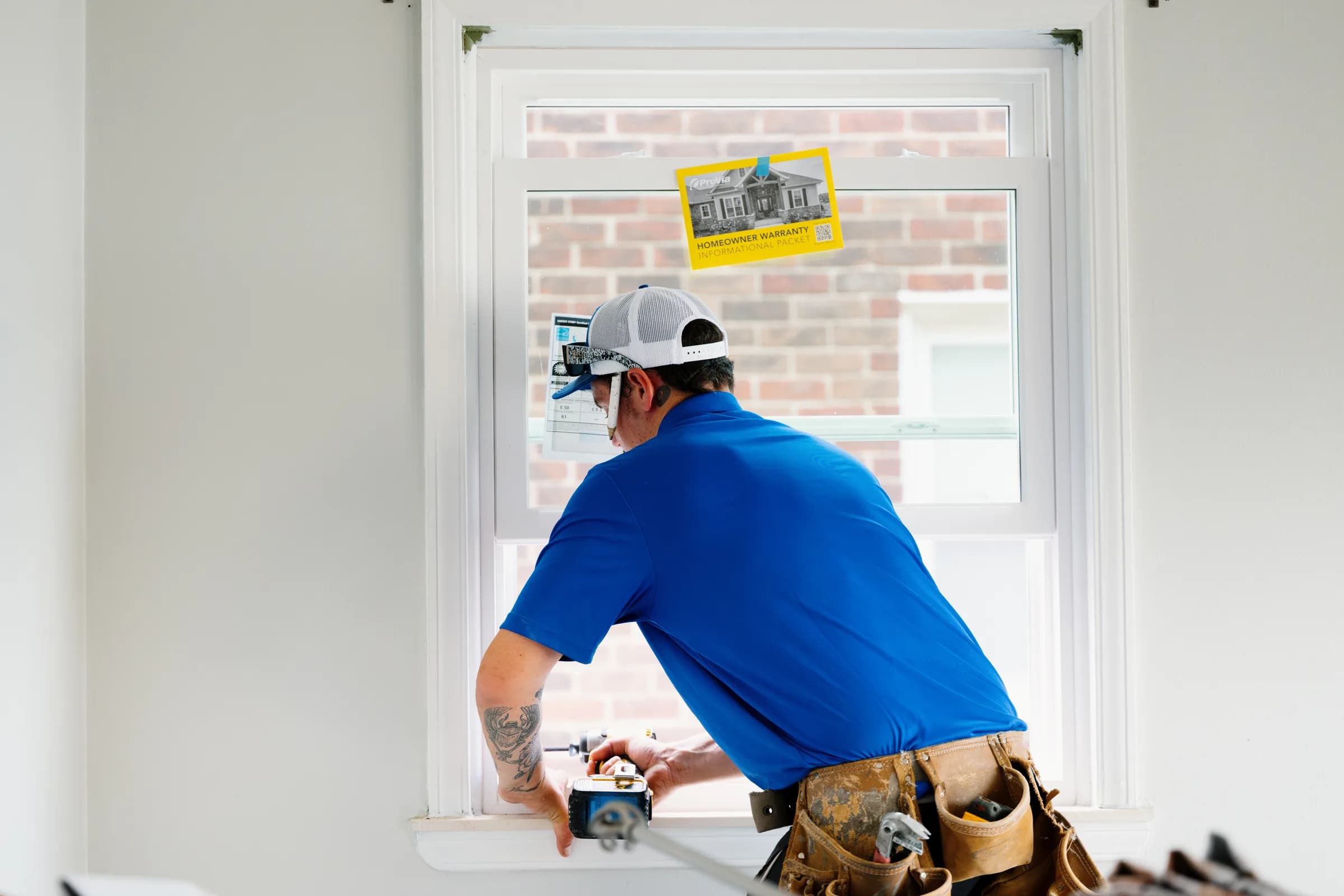 Adkins & Sons installer finishing the interior sill of a new replacement window