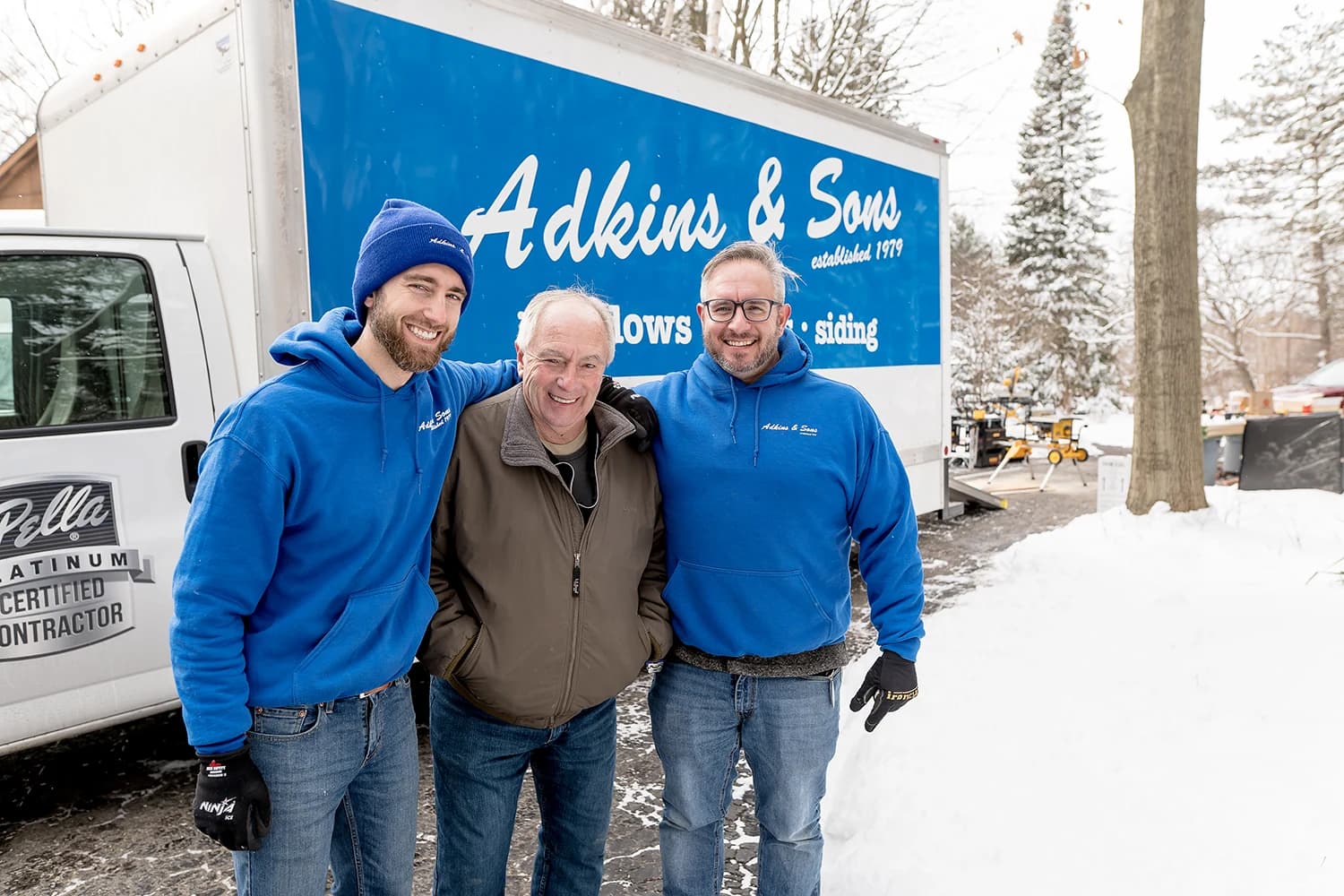Three generations of the Adkins family in front of the company truck