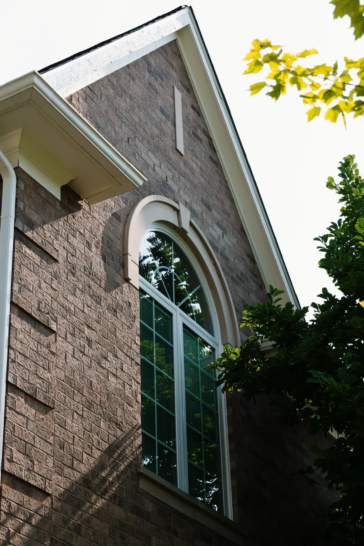 Gable end with a new arched window on an Ann Arbor brick home