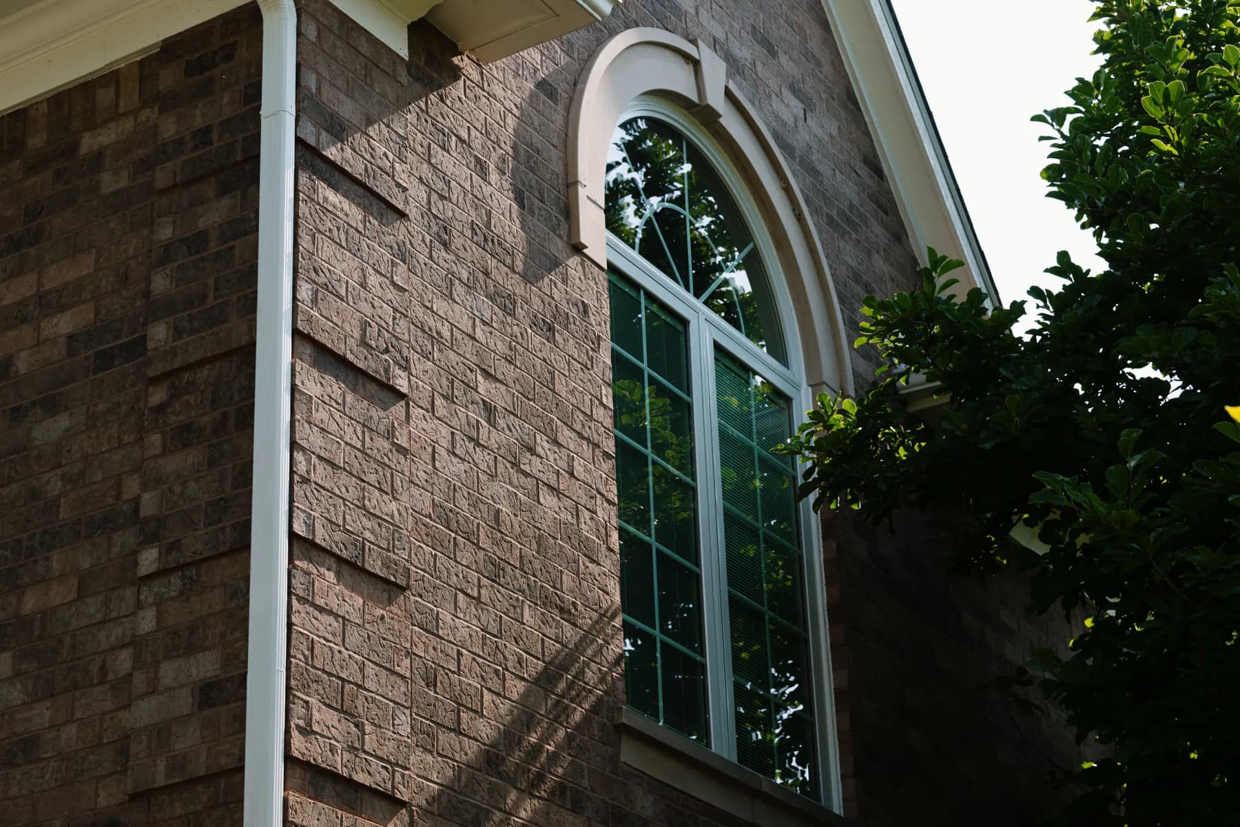 Arched window in dark brick, Ann Arbor