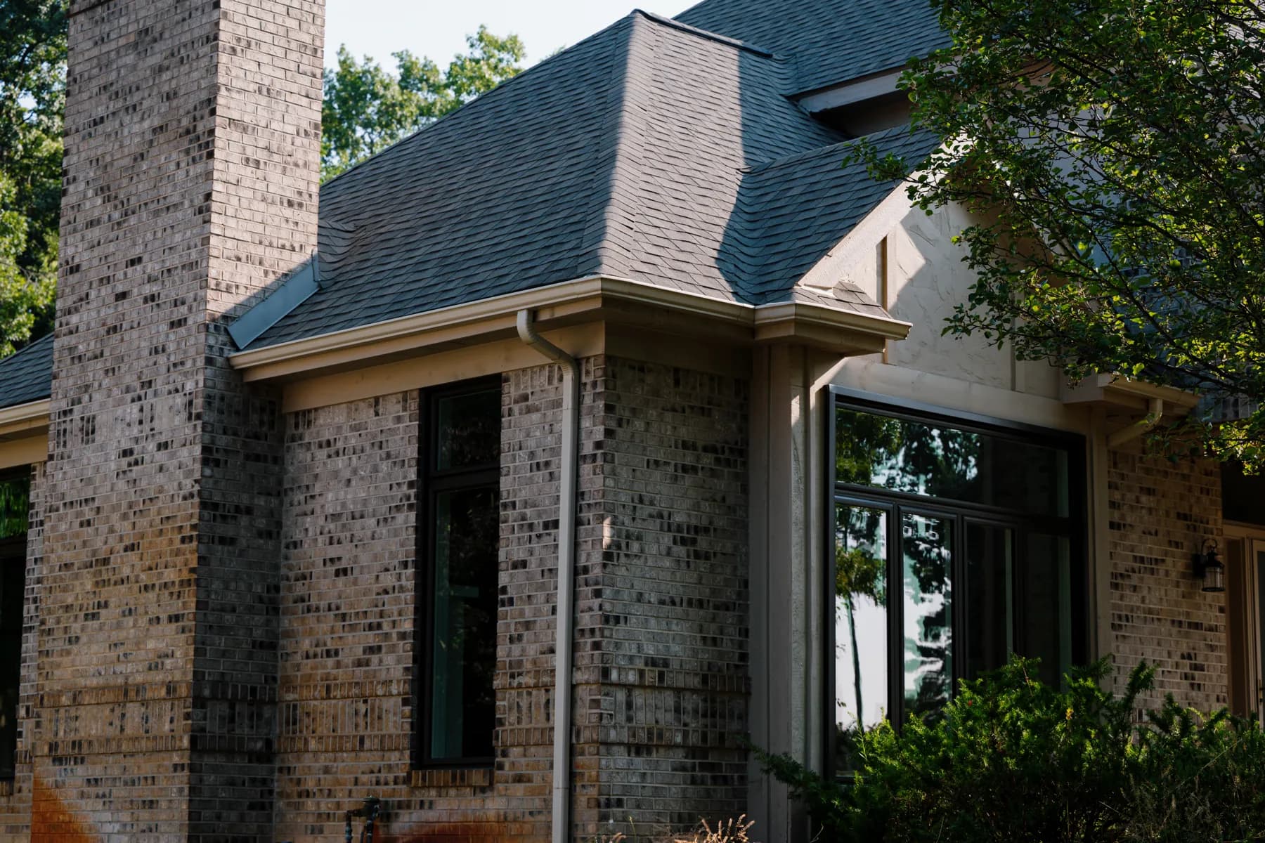 Brick two-storey with new black-framed windows, Livonia