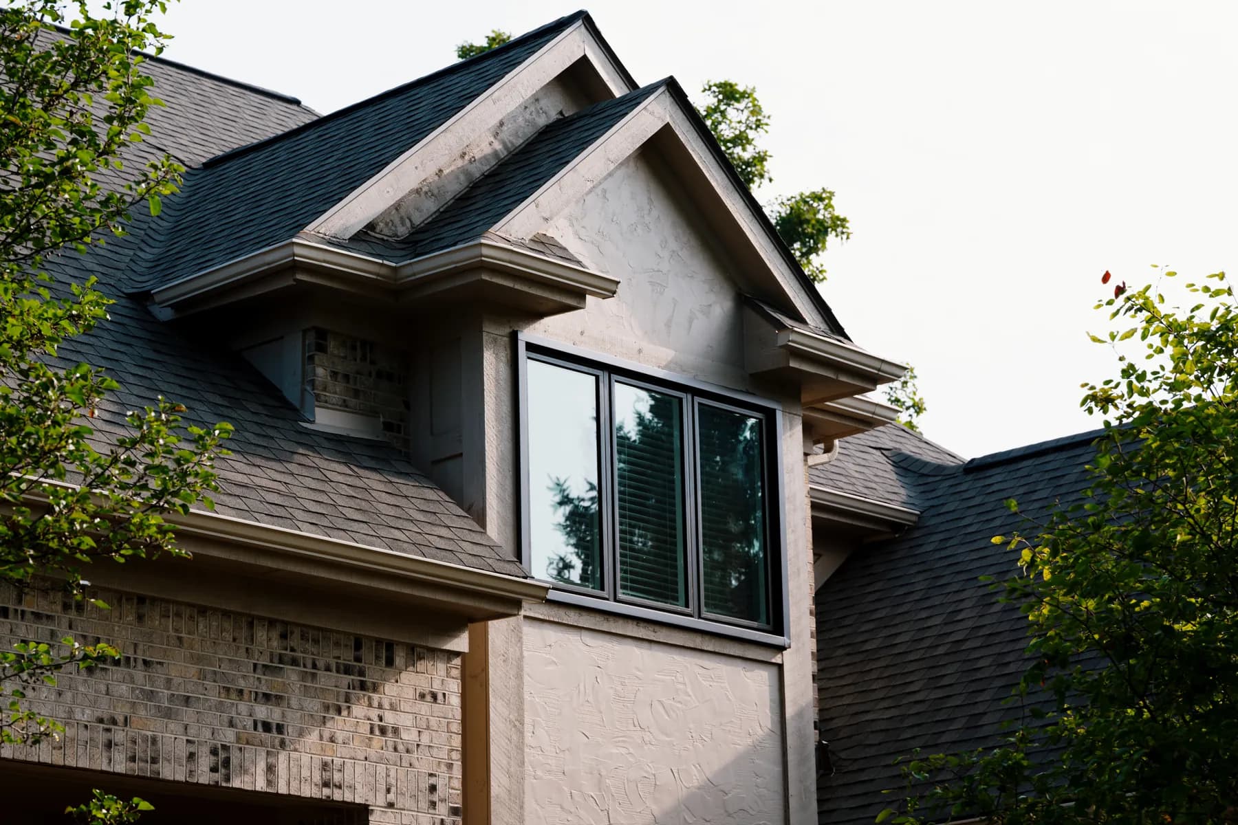 Stucco gable with a new black-framed window, Livonia