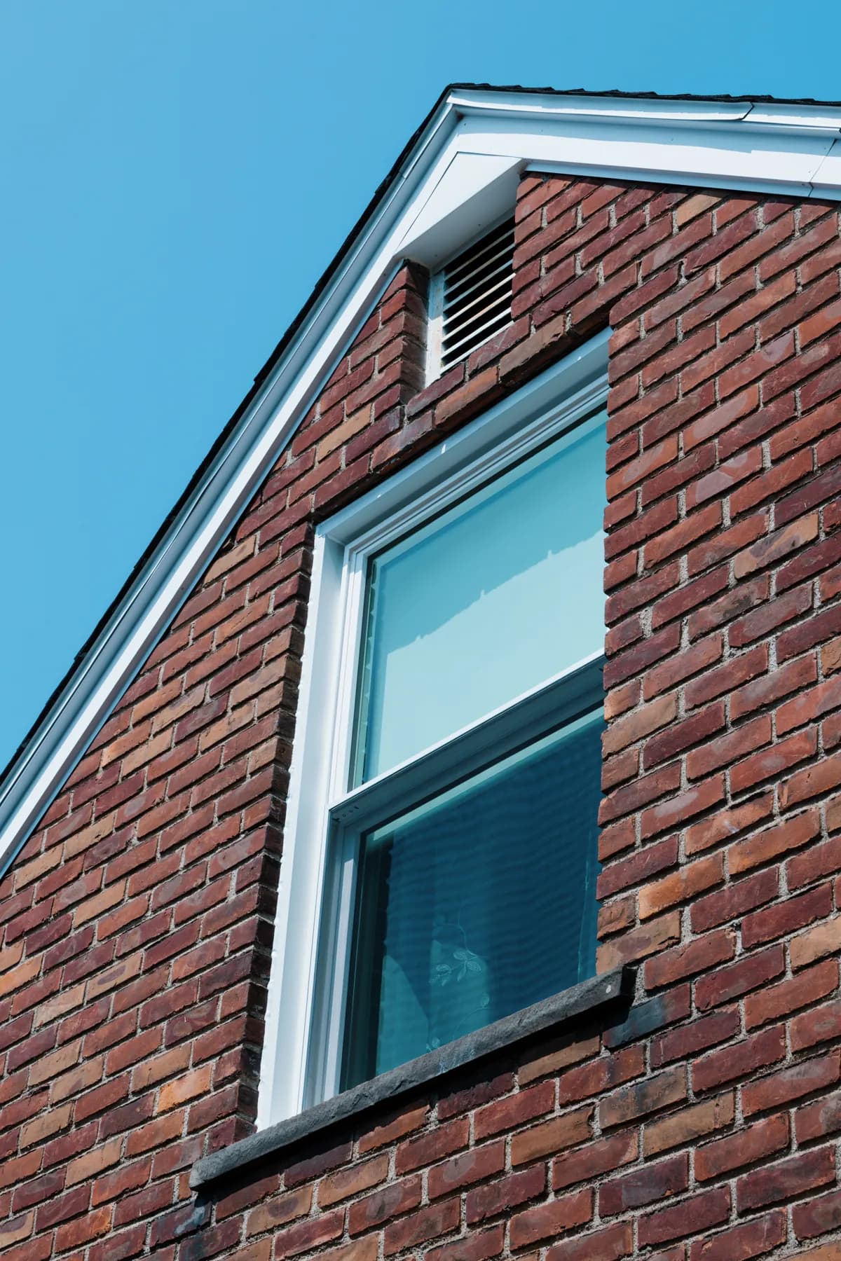 Gable double-hung window with white trim, Southgate