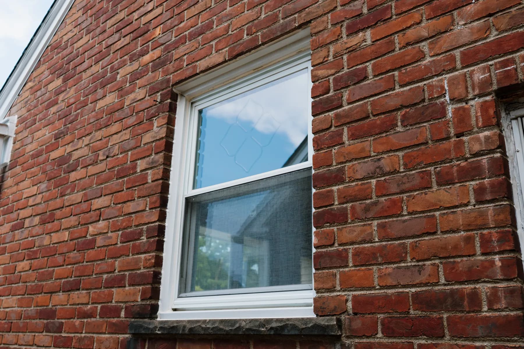 White double-hung replacement window in brick, Southgate