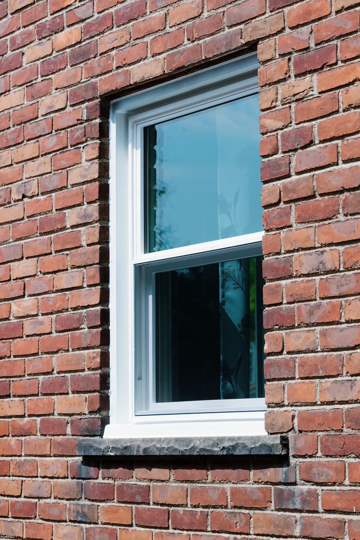 Double-hung replacement window set into brick, Southgate
