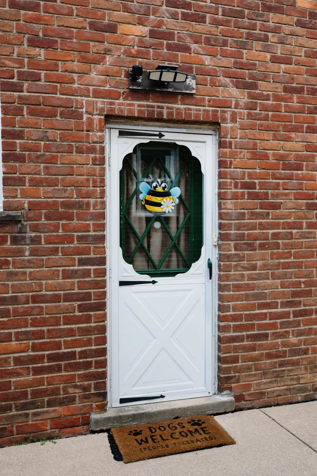 White storm door with a glass panel on a Southgate brick home