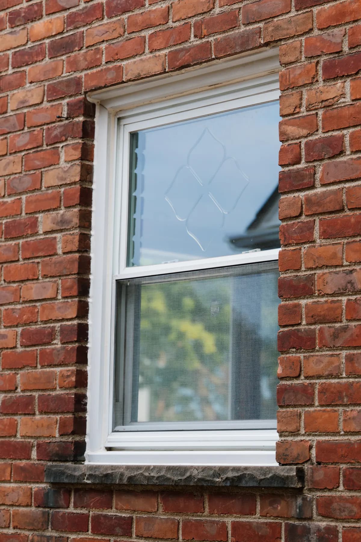 Double-hung window with diamond grids set in brick, Southgate