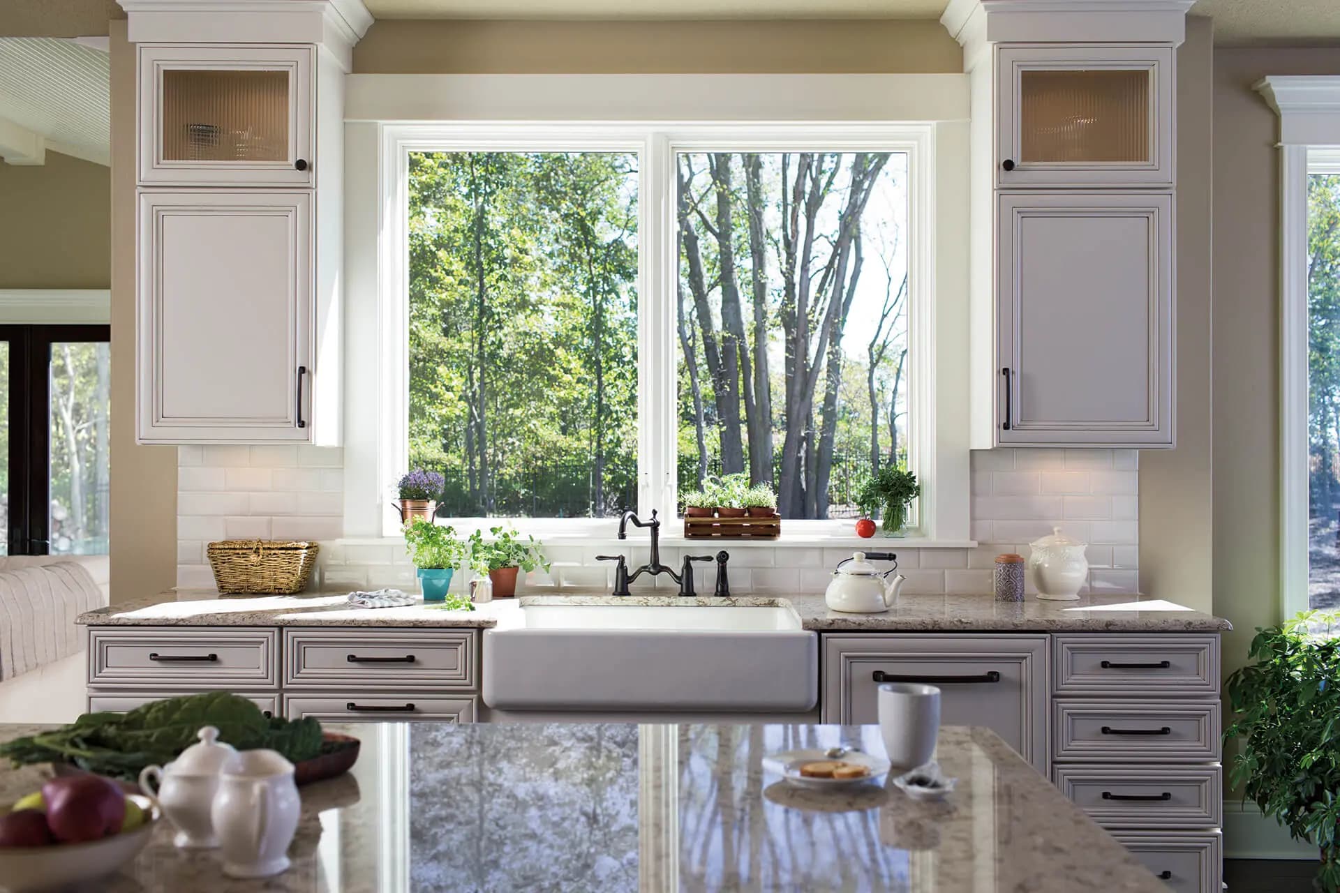Two white casement windows with clear glass above a kitchen sink