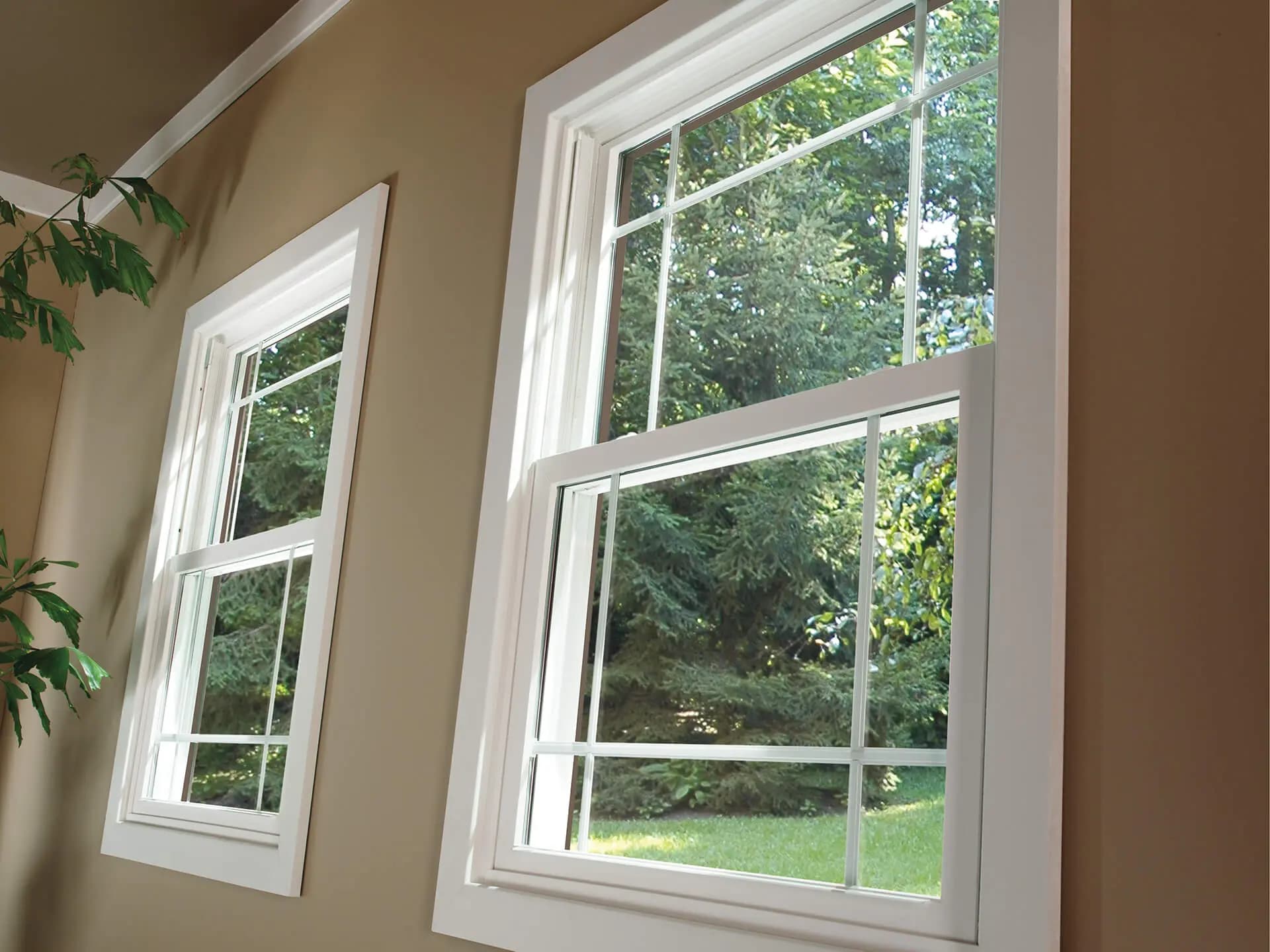 White vinyl double-hung windows with grilles between the glass