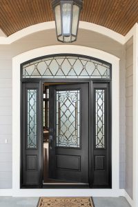 A black front entry door with sidelites
