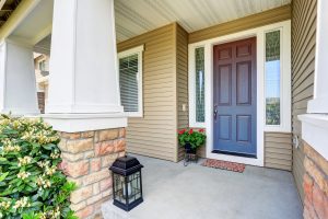 A dark brown entry door with sidelites